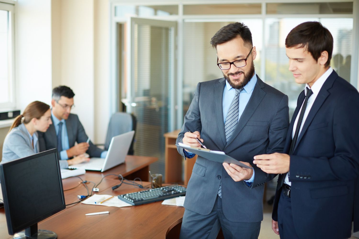 Two accountants reviewing a document together in an office
